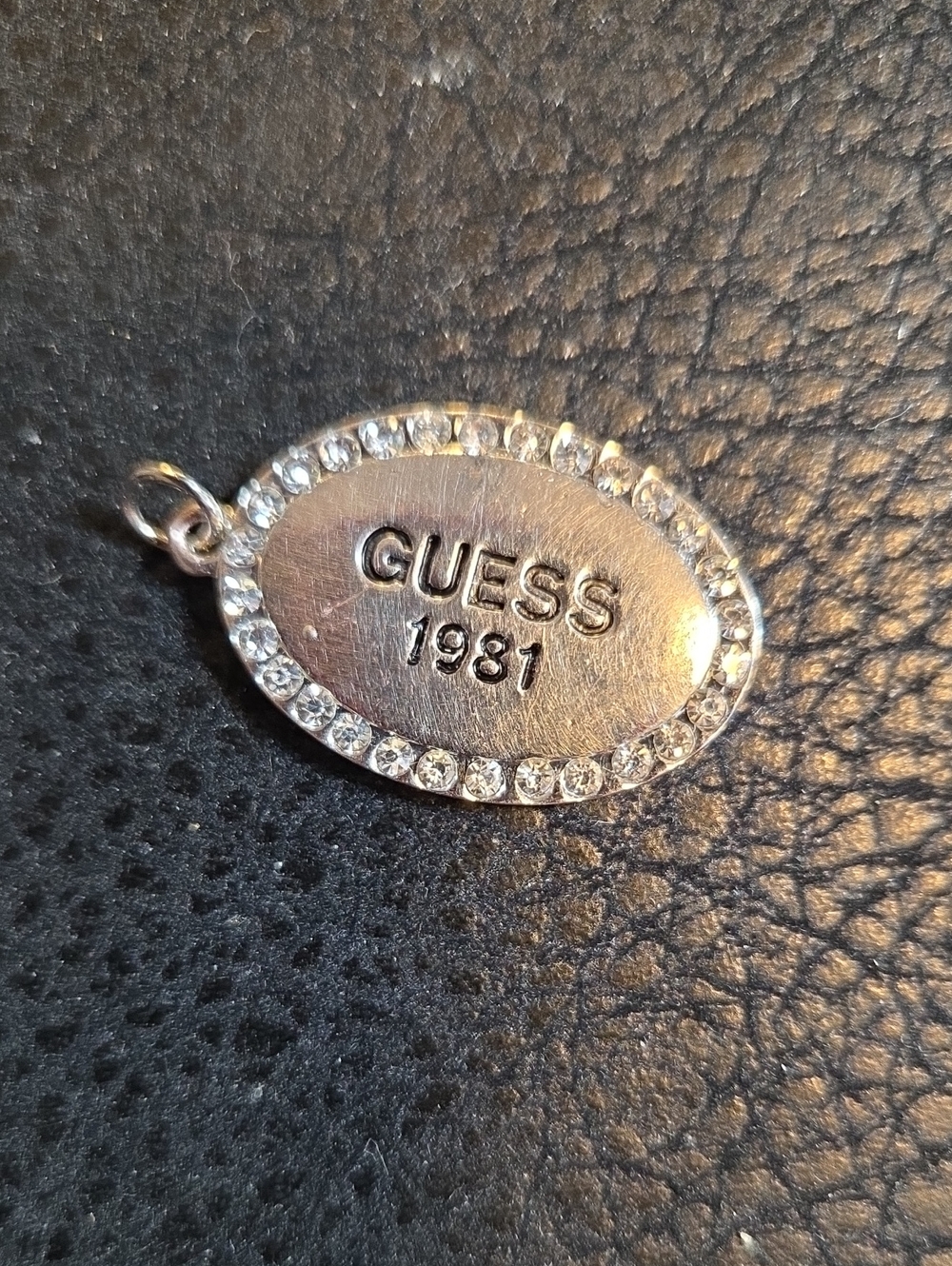Guess  1981 Silver-Tone Oval Logo Charm with Crystal Border